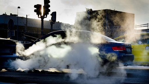 Car with visible fumes from the exhaust.
